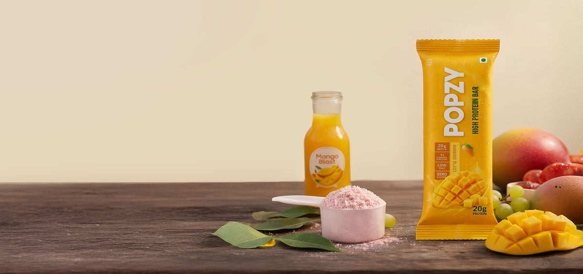 POPZY protein bar with a bottle of juice and fruits on a wooden table